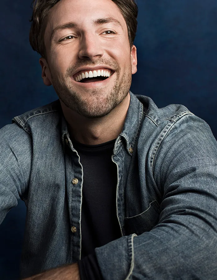 Adult male smiling after orthodontic treatment